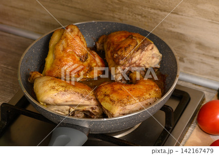 Cooking tender chicken pieces in a skillet, releasing mouthwatering aromas and inviting flavors Cooking tender chicken pieces in a skillet, releasing mouthwatering aromas and inviting flavors 142167479