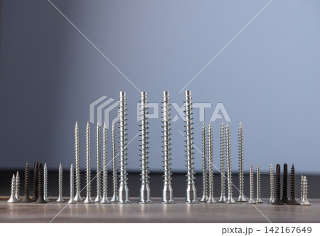 Unique arrangement of screws creating a striking visual composition in soft light Unique arrangement of screws creating a striking visual composition in soft light 142167649