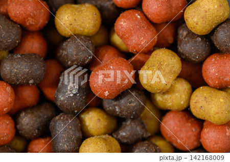 Colorful assortment of pet food pellets creating a vibrant feast for hungry companions Colorful assortment of pet food pellets creating a vibrant feast for hungry companions 142168009