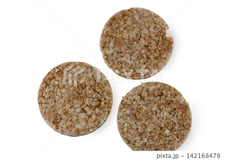 Three round whole grain rice cakes arranged separately on a white background Three round whole grain rice cakes arranged separately on a white background 142168479