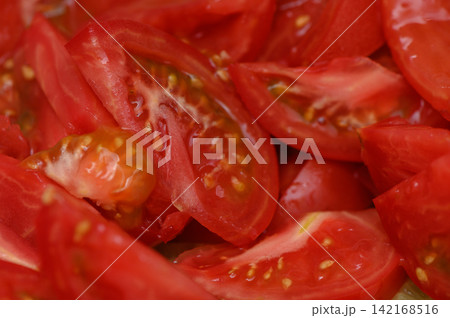 Fresh red tomato slices glistening with juice, ready to enhance any dish with vibrant flavor and color Fresh red tomato slices glistening with juice, ready to enhance any dish with vibrant flavor and color 142168516