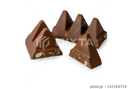 Broken pieces of Toblerone milk chocolate with visible almond and honey nougat on a white background Broken pieces of Toblerone milk chocolate with visible almond and honey nougat on a white background 142168710