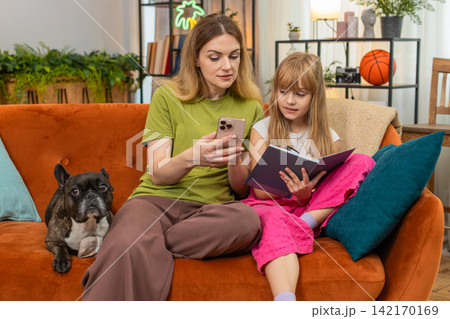 Mother daughter dog study math on smartphone lesson explain write notes solve problem hooray cheer 142170169