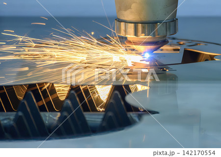 Close up of laser beam and splashing light at nozzle tip of fiber laser cutting machine Close up of laser beam and splashing light at nozzle tip of fiber laser cutting machine 142170554