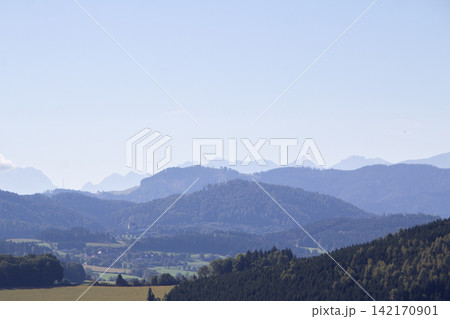 Cumulus clouds above the mountain ridge at the horizon. Vistara in the Gurktal valley, Carinthina, Austria, near Althofen. Cumulus clouds above the mountain ridge at the horizon. Vistara in the Gurktal valley, Carinthina, Austria, near Althofen. 142170901