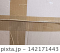Cardboard box surface with clear packing tape sealing 142171443