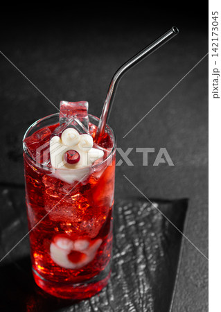 Spooky Halloween Red Cocktail Decorated with Ghostly Marshmallow and Cranberry with Metal Straw and Ice Cubes Spooky Halloween Red Cocktail Decorated with Ghostly Marshmallow and Cranberry with Metal Straw and Ice Cubes 142173045