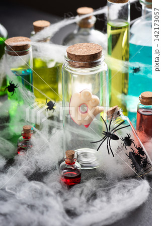 Halloween spooky laboratory potion bottles with spiders and cobwebs for a festive theme Halloween spooky laboratory potion bottles with spiders and cobwebs for a festive theme 142173057