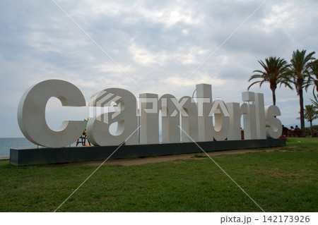 Cambrils, Spain, August 27 2017: Large Cambrils city sign at the promenade with palm trees 142173926