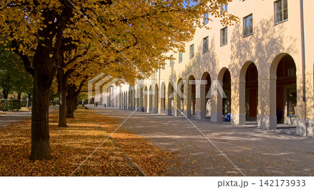 Munich, Germany, October 12 2015: Historic building with arcades in autumn park sunshine Munich, Germany, October 12 2015: Historic building with arcades in autumn park sunshine 142173933