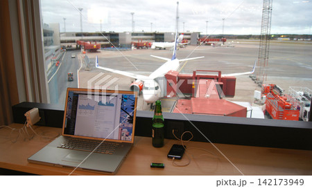 Stockholm, Sweden, December 10 2015: Working in airline lounge with apron view and aircraft at gate 142173949