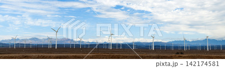 Wind Farm in Desert Landscape with Mountains and Blue Sky Wind Farm in Desert Landscape with Mountains and Blue Sky 142174581