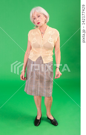 Sad elderly woman looking upset in front of green screen Sad elderly woman looking upset in front of green screen 142177429