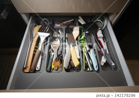 Drawer full of cooking tools and utensils 142178286