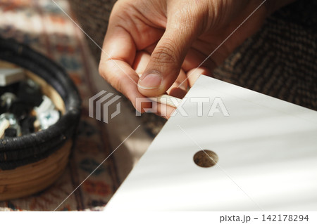 Person working on wood project at home Person working on wood project at home 142178294