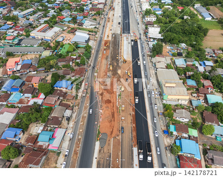 Aerial Photo of Urban Highway Expansion Construction with Fresh Asphalt and Traffic 142178721