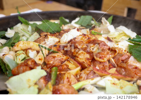 Spicy Korean Chicken Stir Fry Dakgalbi with Vegetables on Iron Pan Spicy Korean Chicken Stir Fry Dakgalbi with Vegetables on Iron Pan 142178946