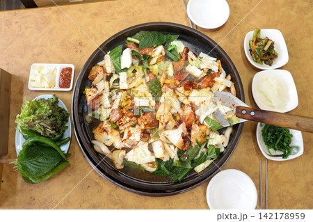 Spicy Korean Chicken Stir Fry Dakgalbi with Vegetables on Iron Pan Spicy Korean Chicken Stir Fry Dakgalbi with Vegetables on Iron Pan 142178959