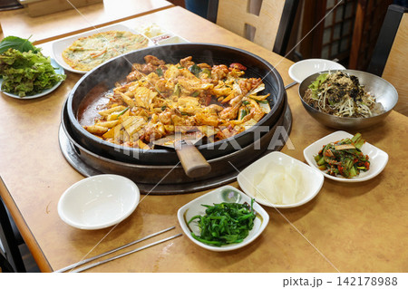 Spicy Korean Chicken Stir Fry Dakgalbi with Vegetables on Iron Pan Spicy Korean Chicken Stir Fry Dakgalbi with Vegetables on Iron Pan 142178988