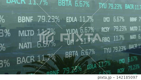Flickering ticker overlay covering coastal skyline on glass, showing stock codes, percentages, palm 142185097