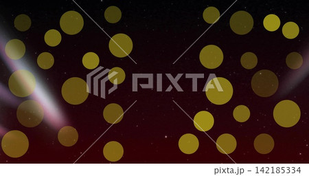 Shimmering golden bokeh discs drifting over burgundy-black gradient, two pale beams and star specks. Circles, orbs, amber, metallic, ambient, abstract, night 142185334