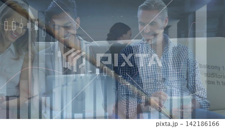 Analyzing financial graphics, team using laptop and tablet in modern lounge, man in checkered shirt 142186166
