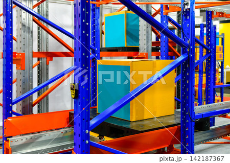 Industrial cardboard box package stored on automated racking system in smart logistics warehouse Industrial cardboard box package stored on automated racking system in smart logistics warehouse 142187367