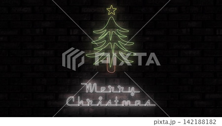 Glowing neon tree, yellow star, pink trunk and Merry Christmas casting soft halos on brick wall 142188182