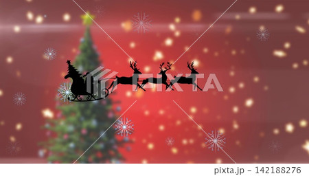 Gliding Santa shadow riding sleigh pulled by three reindeer across holiday card, with tree and star 142188276