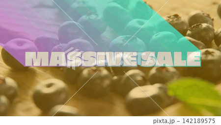 Showing blueberry cluster on wood board with MASSIVE SALE text, purple teal overlays and green leaf 142189575