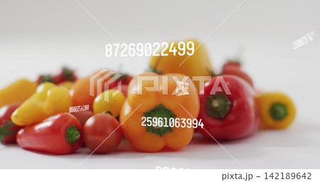 Showing orange bell pepper with red or yellow peppers and cherry tomato on white tabletop, numbers 142189642