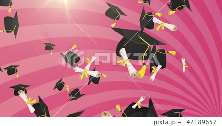 Tossing black caps yellow-tasseled and scrolls yellow-ribboned across pink stripes, bright flare Tossing black caps yellow-tasseled and scrolls yellow-ribboned across pink stripes, bright flare 142189657