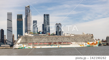 New York, USA - March 31, 2024: Norwegian Getaway cruise ship voyage. Cruise liner at NY port. New York vacation. Norwegian cruise line. Cruise ship tour travel at sea. Ship at cityscape of New York 142190282