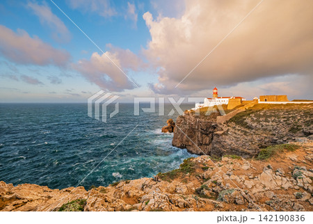Cabo de Sao Vicente lighthouse at sunrise above open Atlantic water Cabo de Sao Vicente lighthouse at sunrise above open Atlantic water 142190836