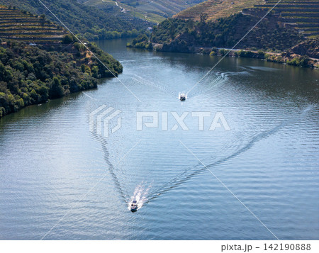 Douro River Boat Wake and Vineyard Valley in Portugal Daylight Douro River Boat Wake and Vineyard Valley in Portugal Daylight 142190888