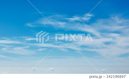 Clear blue sky with soft clouds creating a calming atmosphere during daytime Clear blue sky with soft clouds creating a calming atmosphere during daytime 142190897