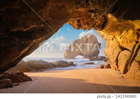 Stunning sunset at Penedo do Guincho from Praia da Santa Cruz grotto Stunning sunset at Penedo do Guincho from Praia da Santa Cruz grotto 142190900
