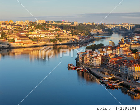 Drone view of Porto Ribeira and Douro River, Portugal, golden hour boats 142191101