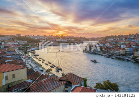 Douro River sunset view in Porto with moving tourist boat and rabelo boats 142191122
