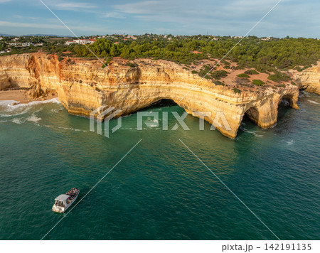 Drone View of a Tourist Tour Boat Near Benagil Cave Drone View of a Tourist Tour Boat Near Benagil Cave 142191135