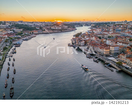 Drone View of Porto Ribeira with tourist boat at sunset 142191213