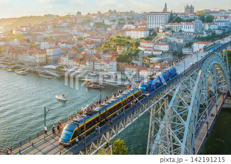Porto sunset tram and river boats by Luis I Bridge near the waterfront Porto sunset tram and river boats by Luis I Bridge near the waterfront 142191215
