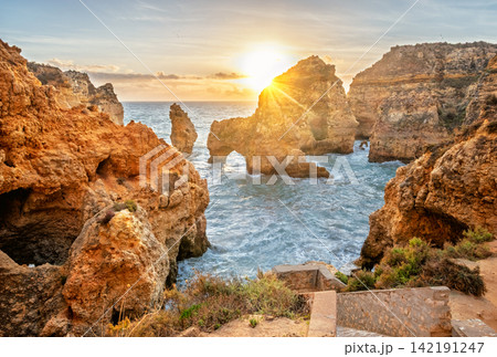 Sunrise sea arch and cliffs at Ponte da Piedade in Lagos, Portugal Sunrise sea arch and cliffs at Ponte da Piedade in Lagos, Portugal 142191247