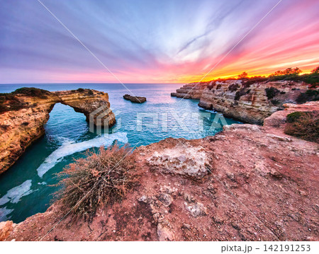 Dramatic Sunset at Arco de Albandeira Beside Sunset Clouds Dramatic Sunset at Arco de Albandeira Beside Sunset Clouds 142191253
