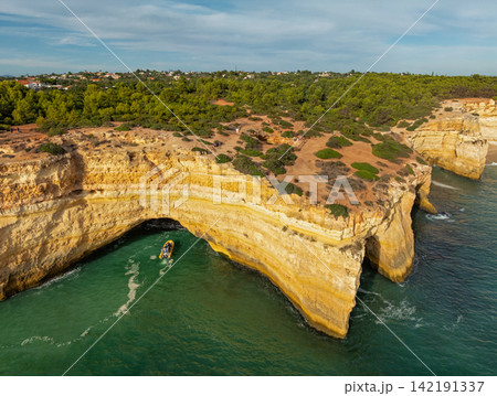 Drone View of Benagil Cave Cliffs With Tourist Tour Boat Drone View of Benagil Cave Cliffs With Tourist Tour Boat 142191337