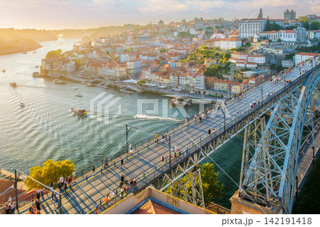 Porto sunset river boats near Luis I Bridge over Douro River high angle view Porto sunset river boats near Luis I Bridge over Douro River high angle view 142191418
