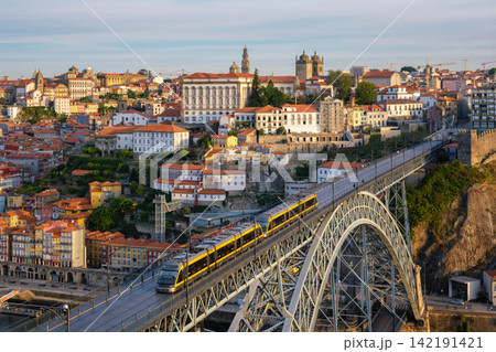Porto sunrise tram on Luis I Bridge above Douro River city panorama Porto sunrise tram on Luis I Bridge above Douro River city panorama 142191421