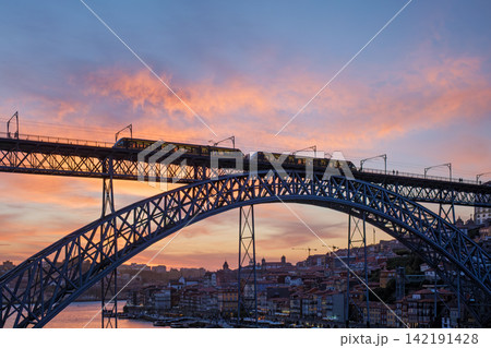 Tram on Dom Luis I Bridge in Porto at dramatic sunset Tram on Dom Luis I Bridge in Porto at dramatic sunset 142191428