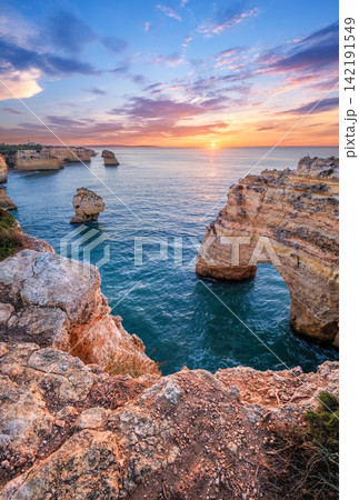 Praia da Marinha beach bright ocean cliffs and sea stacks Algarve Portugal 142191549
