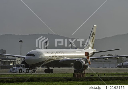 夕暮れの仙台空港　飛行機とトーイングトラクター　27から　宮城県名取市 142192153